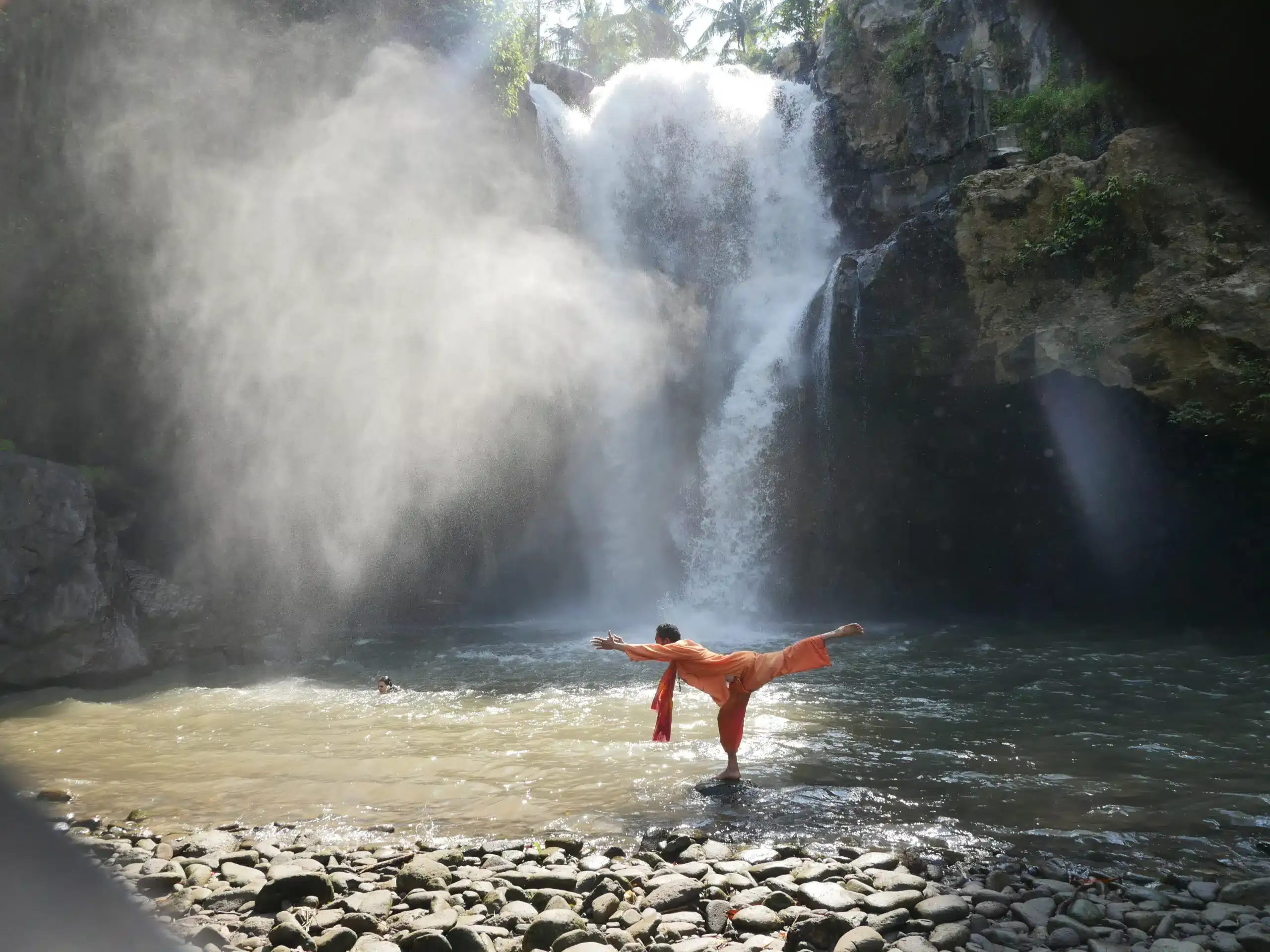 yoga under cascade water in Bali